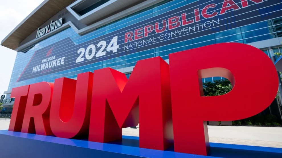 A large group of letter statues spelling out TRUMP outside of a convention center.